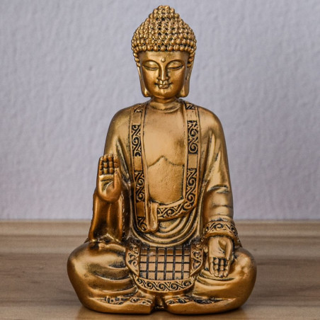 Cette statue représente un Bouddha de couleur or en position de méditation. Cette statue représente un Bouddha de couleur or en position de méditation.